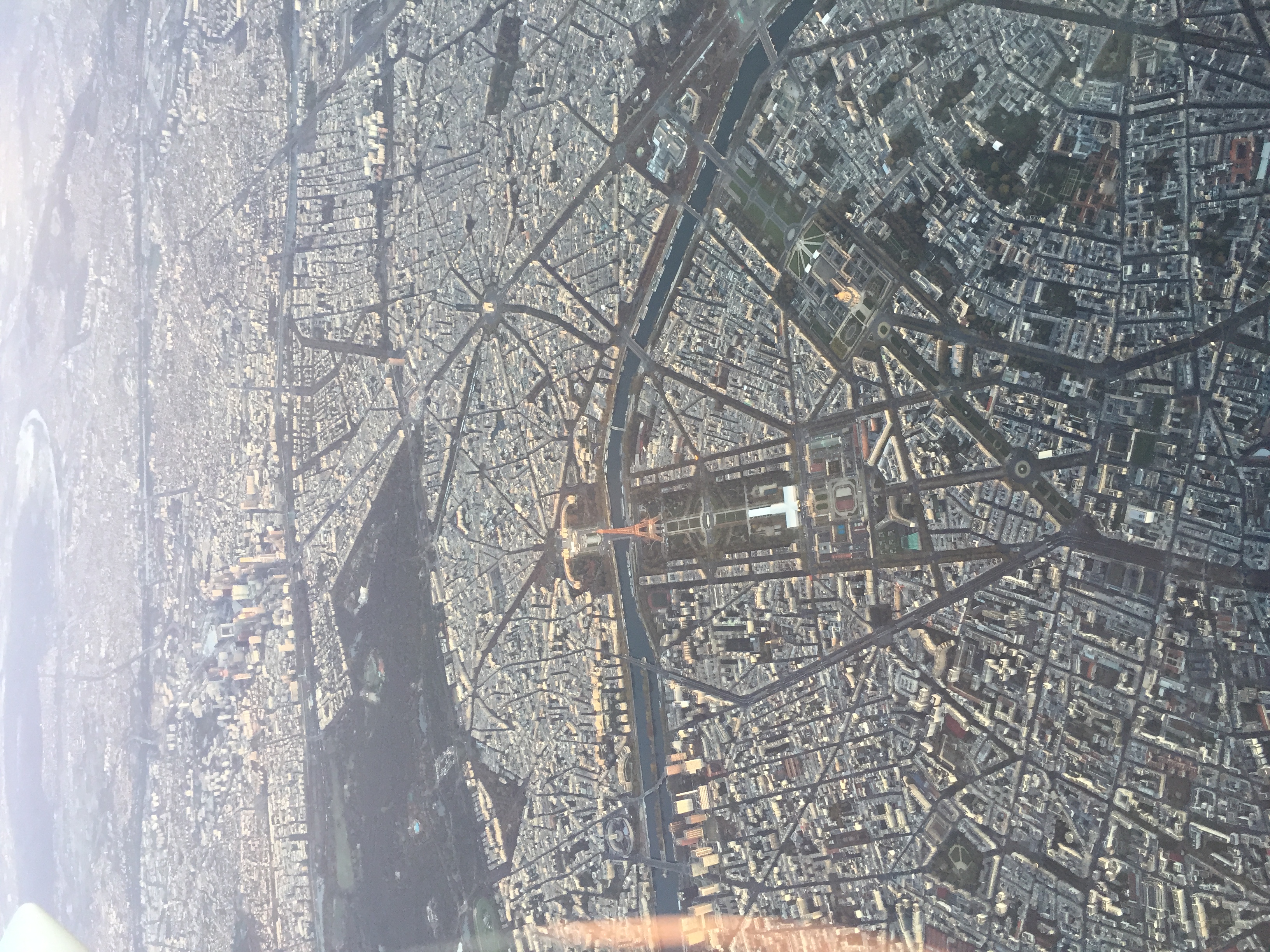 Aerial view of Paris showcasing the Eiffel Tower in a dusk glow