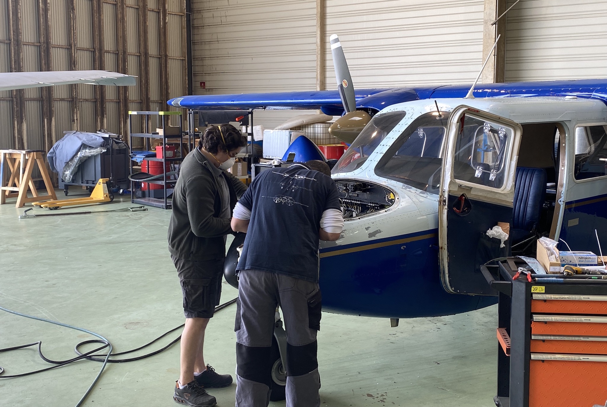 Aircraft engineers working on aircraft avionics bay