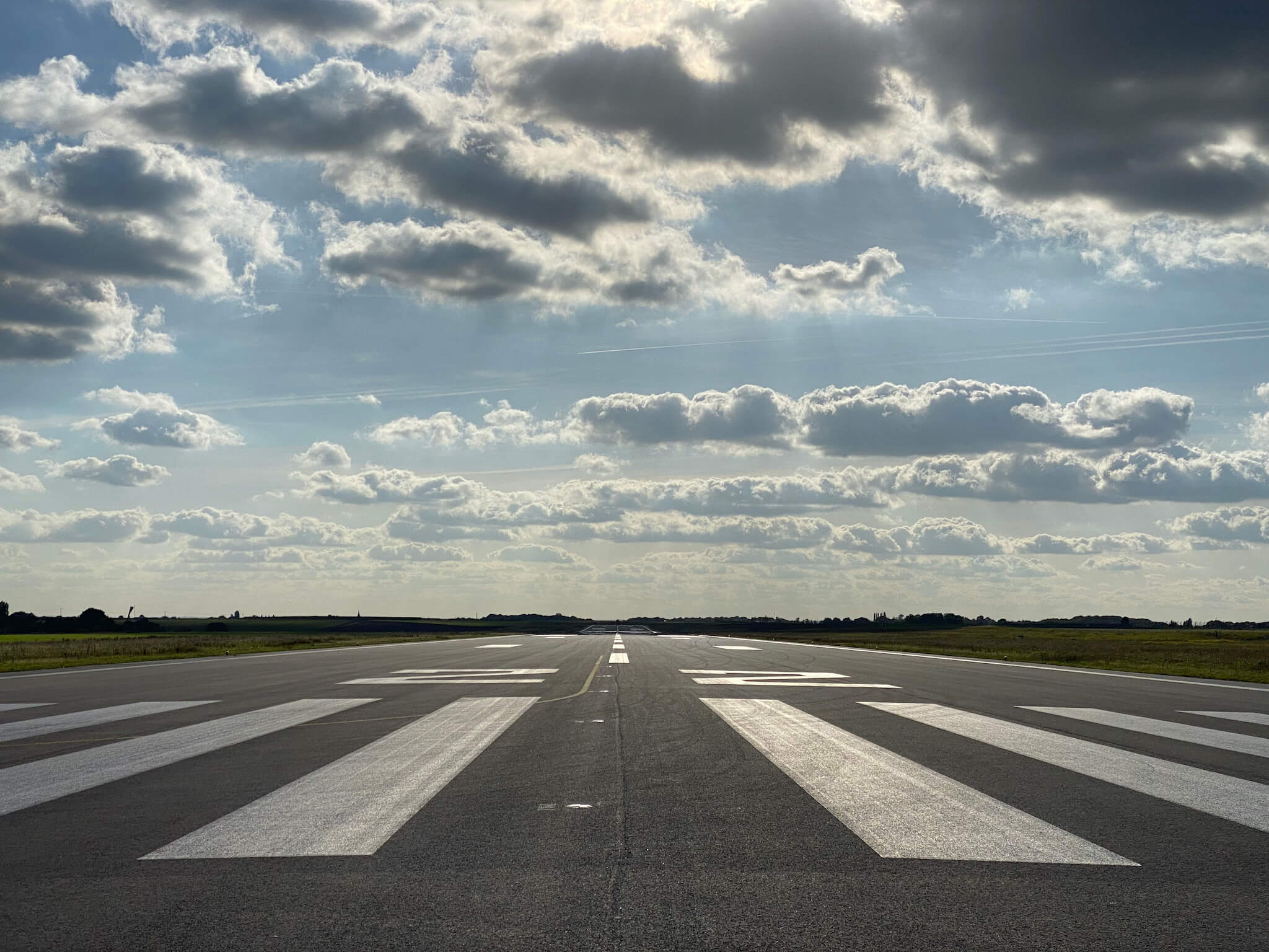 Runway 22 in Rouen under blue sky with scattered clouds during daytime